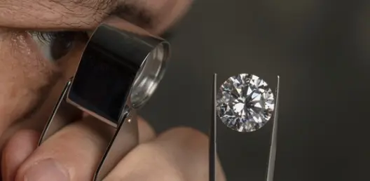 large diamond engagement ring on pink background